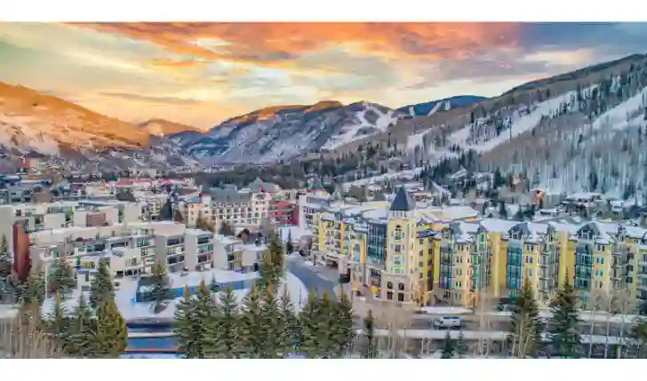 Vail town is shown in the picture with a view of ski resort and ski area in background