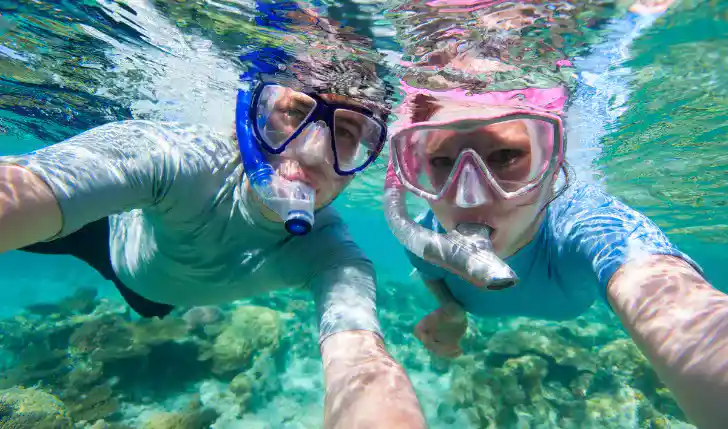 Couple snorkel at Coco Cay