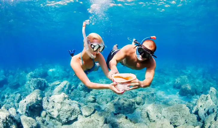 A couple snorkelling at Coco Cay, Bahamas
