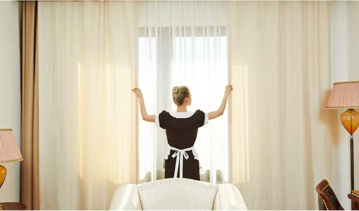The image shows a maid in the hotel room opening the curtains. If you do not get the room service or amenities as promised then you can raise a dispute for refund of money