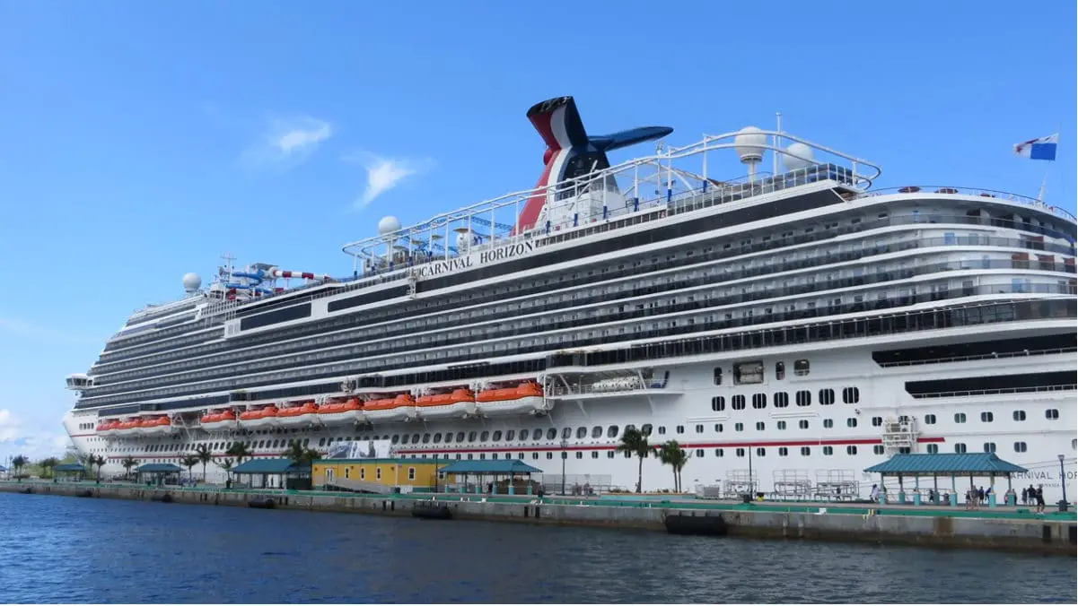 A CArnival cruise ship is shown in the picture while discussing why is carnival cruise so cheap