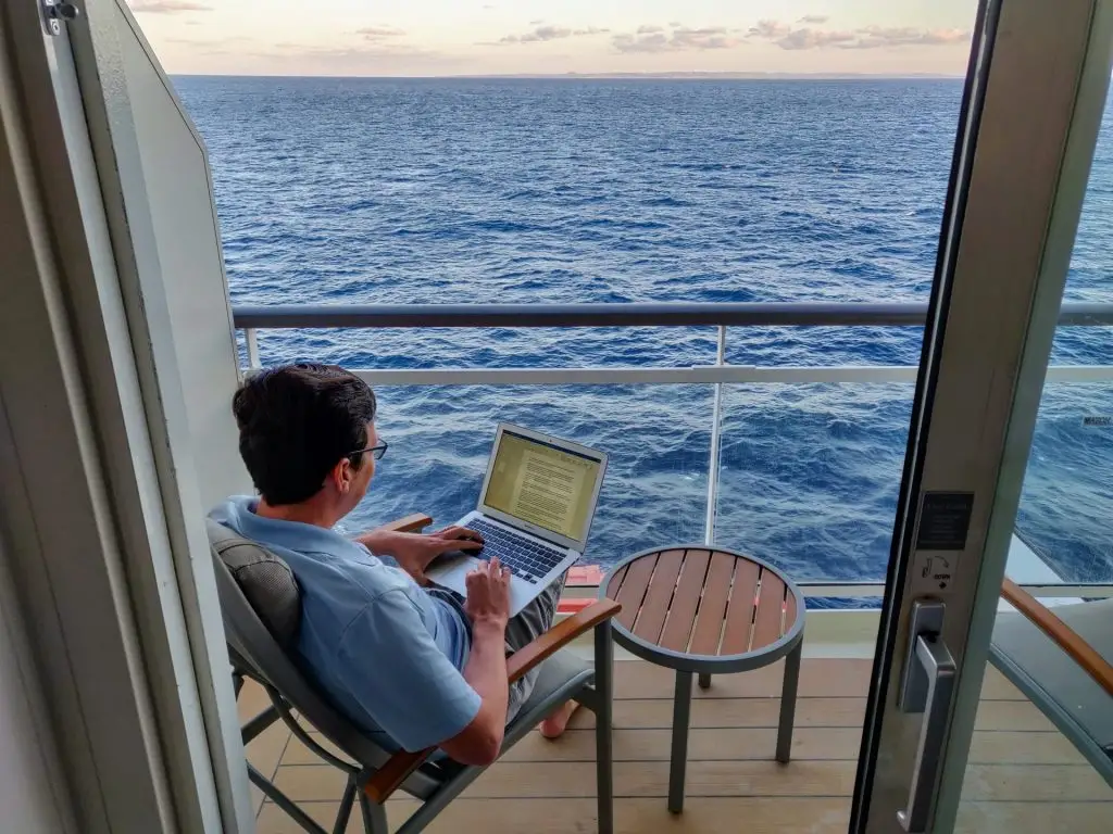 A person enjoying working on his laptop during a cruise on carnival ship 