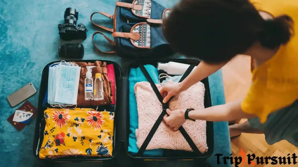 A girl is packing her suitcase for travel